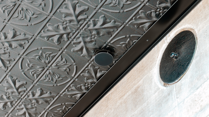 Stainless steel soffit cover for overflow pipe exit