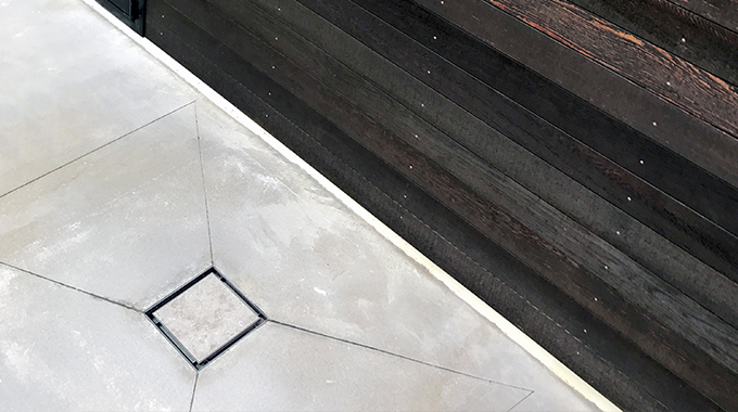 Allproof square plastic drainage pit with tile insert grate installed in concrete