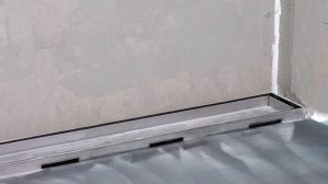 Tile-over-stainless-steel-shower-tray-base-wth-linear-channel-strip-drain-tile-insert-grate-close