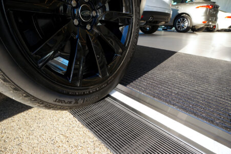 Car level threshold channel strip drain