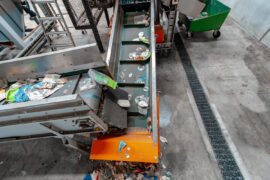 PP entering the cleaning and chipping process with Allproof Commercial Channel installed alongside conveyor belt.